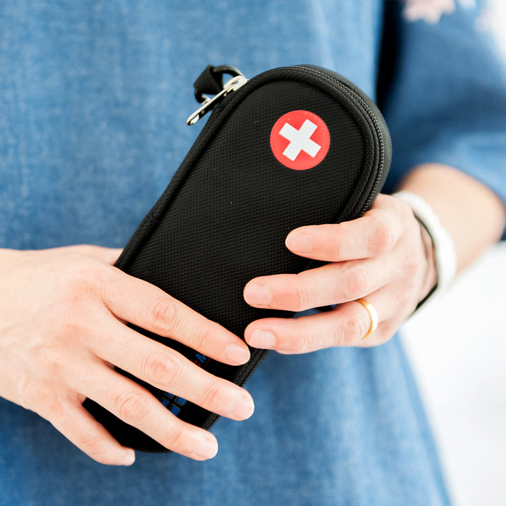 Slim black medicine case with wrist strap, zipper closure, and red medical cross symbol – designed to carry epinephrine, inhalers, or emergency medications securely for everyday or travel use.